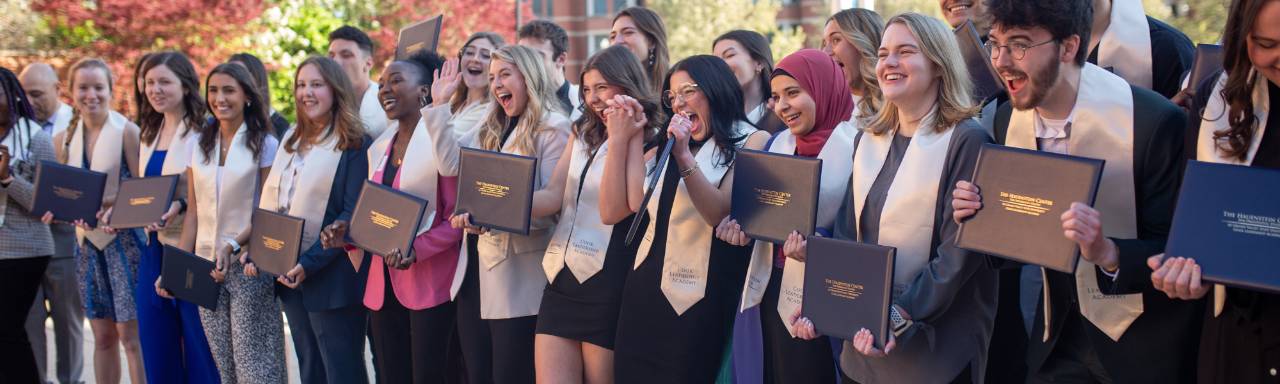 a group of people holding diplomas